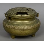 A large Oriental brass censor The removable pierced top cast with flowers,