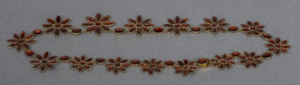 A Georgian garnet set necklace Each flowerhead link and interspacing stone closed backed.