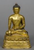 A Chinese gilt bronze Buddha Typically modelled seated in the lotus position. 16 cm high.