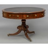 An early 19th century mahogany drum table The leather inset circular top with frieze drawers and