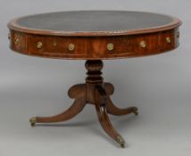 An early 19th century mahogany drum table The leather inset circular top with frieze drawers and