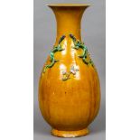 A Chinese porcelain vase With applied dragon and Lingxi decoration on an ochre ground. 55.