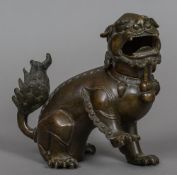 A Chinese patinated bronze censor Formed as a dog-of-fo, the hinged neck revealing a recess.