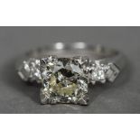 A platinum and diamond three stone ring The central claw set stone spreading to just over 2 carats,
