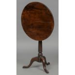 A late 18th/early 19th century yewwood tilt top tripod table The circular top above the turned