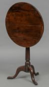 A late 18th/early 19th century yewwood tilt top tripod table The circular top above the turned