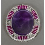A diamond and ruby set 18 ct white gold framed carved amethyst cameo brooch Worked with the