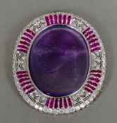 A diamond and ruby set 18 ct white gold framed carved amethyst cameo brooch Worked with the