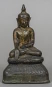 A Ming bronze Buddha Typically modelled seated in the lotus position, with traces of gilding. 19.