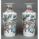 A pair of Chinese porcelain vases Each decorated with a dignitary and attendants. Each 42 cm high.