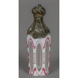 A 19th century white metal mounted cameo glass scent bottle The faceted body cased in white and red.