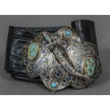 A Russian niello decorated silver buckle With central dagger form fastener and turquoise cabochons,