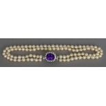 A two strand pearl necklace Set with an unmarked white gold or platinum,