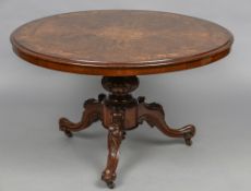 A marquetry inlaid Victorian burr walnut tilt-top breakfast table The florally inlaid circular top