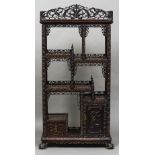 A 19th century Chinese carved hardwood side cabinet Decorated throughout with carved and pierced