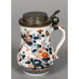 A 17th century Japanese Arita porcelain gilded white metal mounted tankard The hinged stepped cover