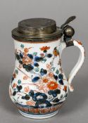 A 17th century Japanese Arita porcelain gilded white metal mounted tankard The hinged stepped cover