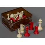 A late 19th/early 20th century carved and red stained Staunton pattern chess set In mahogany box.