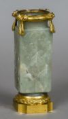 A Chinese carved pale green jade kong vase, possibly Ming Each side worked with a floral spray,