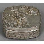 A Chinese repousse decorated silver box The removable lid decorated with floral sprays,