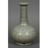 A Chinese porcelain Ge type bottle vase Overall creamy grey glaze suffused with a matrix of dark