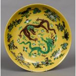 A Chinese porcelain charger Decorated with two five clawed dragons chasing a flaming pearl