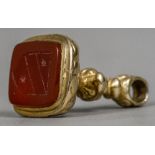 A 9 ct gold fob seal The carnelian carved with a shield; together with a 9 ct gold swing fob.