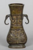 An early Chinese bronze vase With twin elephant mask handles above geometric and scrolling designs