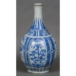 A 17th century Japanese Arita porcelain bottle vase Decorated with foliate vignettes. 49 cm high.