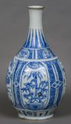 A 17th century Japanese Arita porcelain bottle vase Decorated with foliate vignettes. 49 cm high.