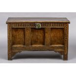 An 18th century three panelled oak coffer The moulded rectangular top above the panelled front with