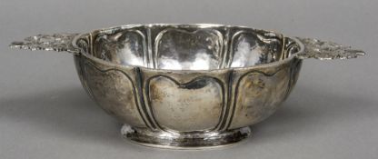 An 18th century Dutch silver brandy bowl Of lobed panel form, with pierced floral handles.