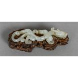 An early 19th century Chinese carved white jade dragon Of slender form,