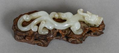 An early 19th century Chinese carved white jade dragon Of slender form,