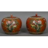 A pair of Chinese orange ground ginger jars Each decorated with various birds amongst trees and