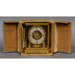 A boxed Atmos clock Of typical form, the silvered dial with Arabic numerals and batons. 23.