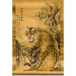 A Chinese painted scroll Worked with a tiger in a mountainous landscape,