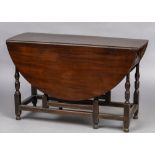 An 18th century mahogany drop leaf gate table Of typical oval form,