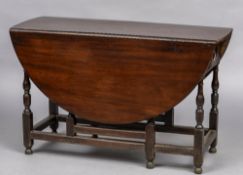 An 18th century mahogany drop leaf gate table Of typical oval form,