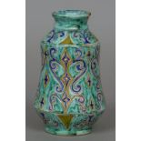 A faience vase Of waisted cylindrical form, decorated with blue scrollwork on a turquoise ground,