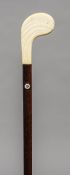 An Art Deco ivory mounted walking stick The handle of golf club form. 90.5 cm long.