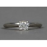 A diamond set platinum solitaire ring The claw set stone spreading to approximately 0.