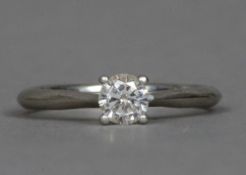 A diamond set platinum solitaire ring The claw set stone spreading to approximately 0.