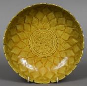 A Chinese mustard yellow ground dish With lappet form rim and central floral motif,