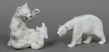 A Royal Copenhagen porcelain animalier group formed as two polar bears Together with another