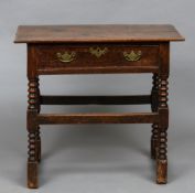 A 18th century oak side table The rectangular top above the single frieze drawer,