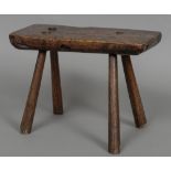 A 19th century elm rustic stool The rectangular seat supported on spreading legs. 40 cm wide.