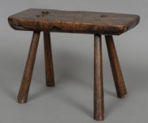 A 19th century elm rustic stool The rectangular seat supported on spreading legs. 40 cm wide.