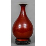 An 18th/19th century Chinese sang de boeuf vase The flared rim above the slender neck and bulbous