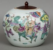 A Chinese porcelain ginger jar and wooden cover The body decorated with figures in a continuous
